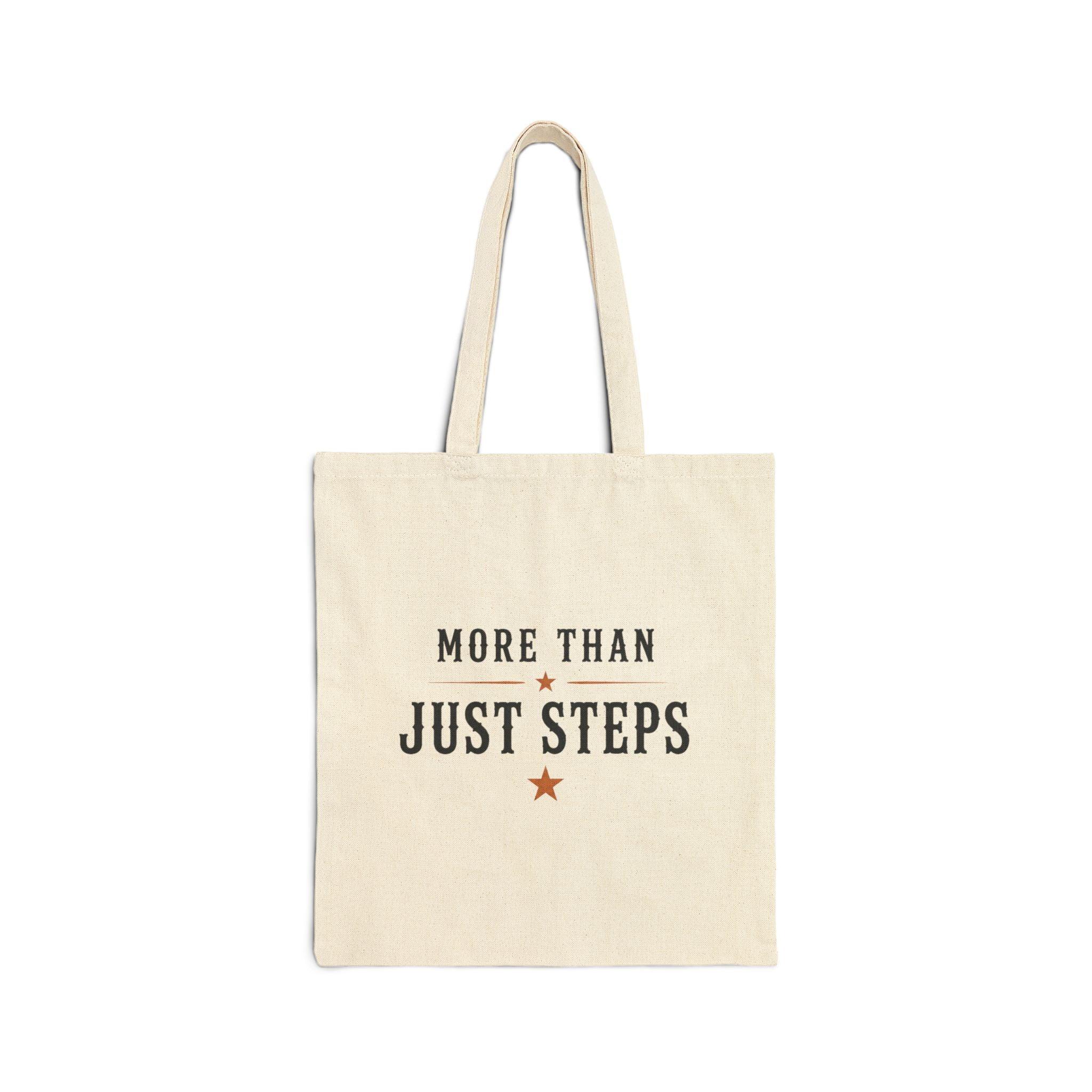 Close-up of the natural cotton tote and printed Step Culture Collective logo.
