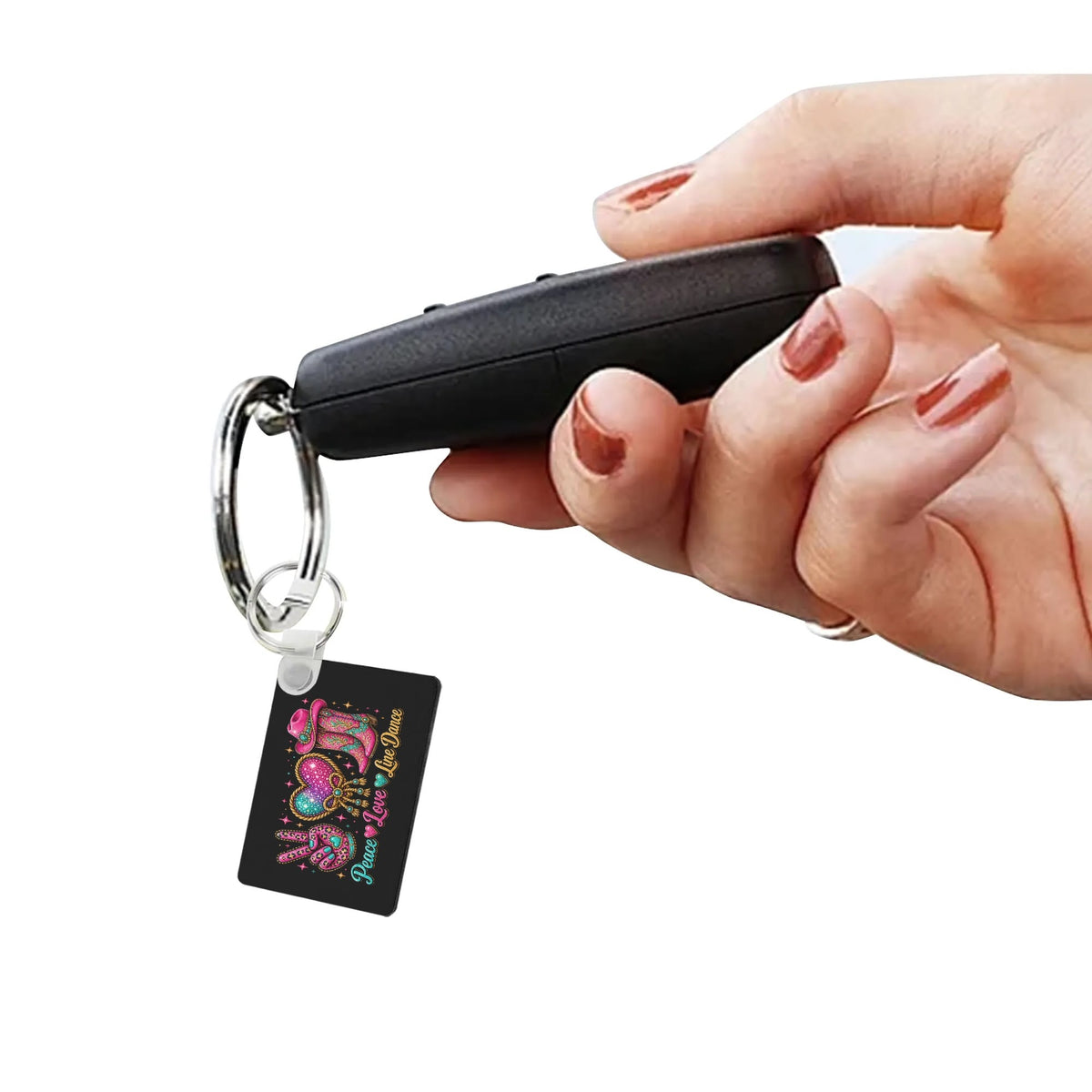 Side view of Peace Love Line Dance MDF keychain showing its thickness and ring attachment
