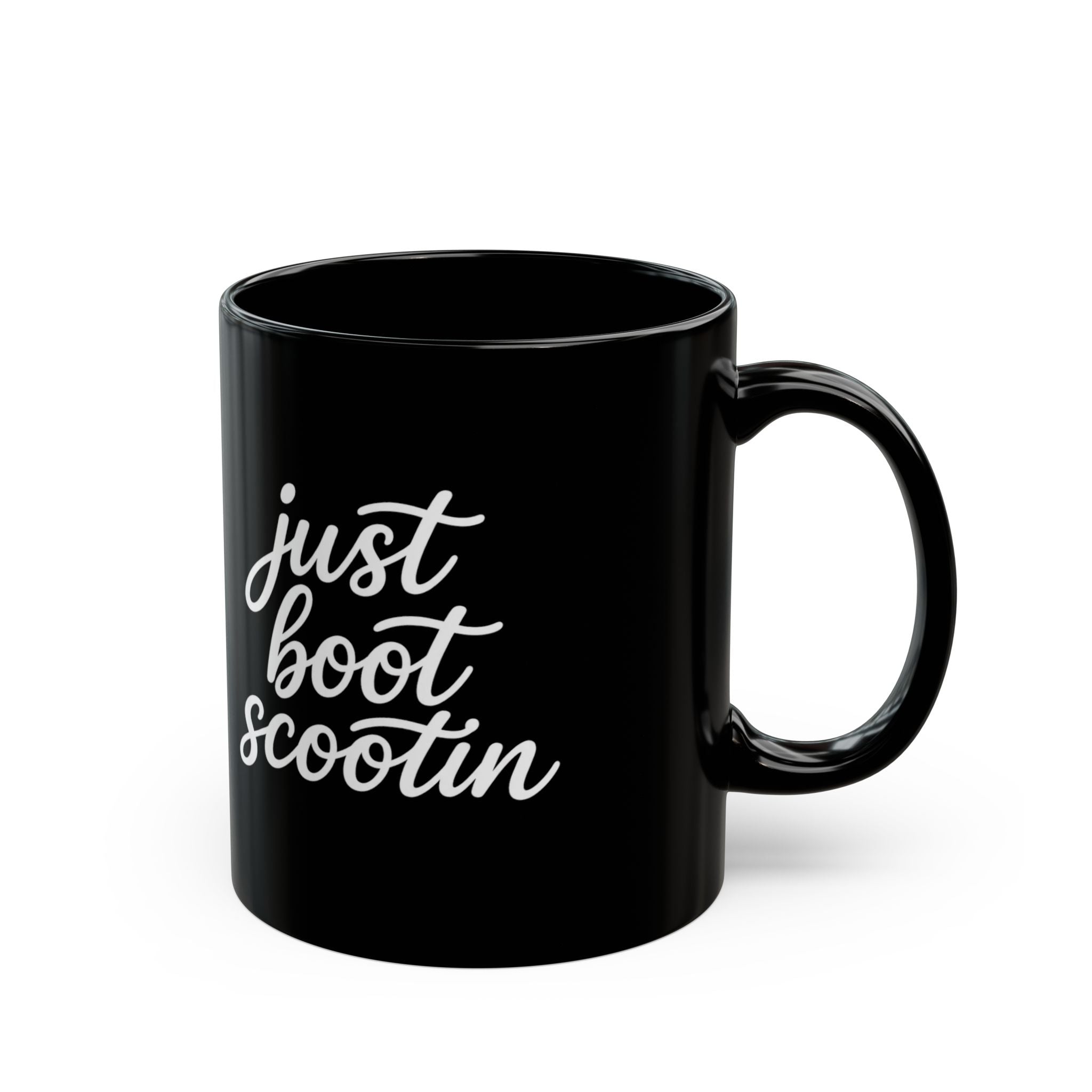 Just Boot Scootin black ceramic mug shown from the front