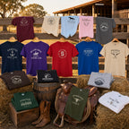 Sixteen personalised Gildan 5000 T-shirt colours displayed on a stable fence, hay bales, barrel, saddle and crate