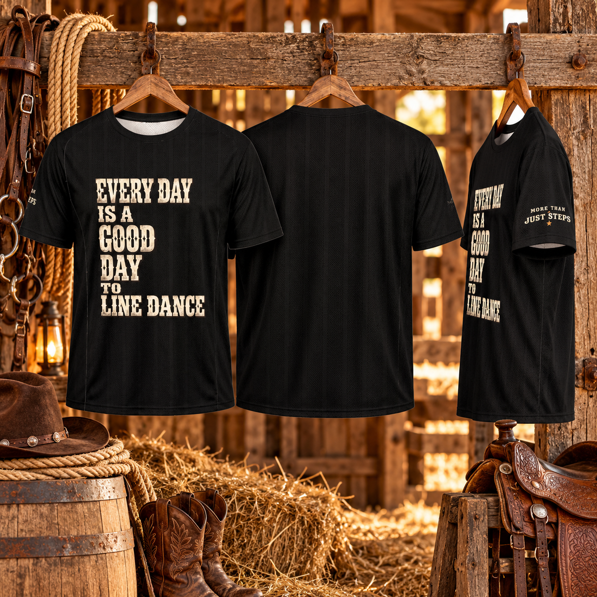 Three black line dancing jerseys on wooden hangers in a rustic stable showing front design, plain back and More Than Just Steps sleeve print
