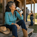 Line dancer drinking from a My Happy Hour Is Line Dancing personalised stainless steel bottle on barn steps