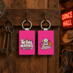 Hot pink No Tags No Restarts Just Dance keyring shown front and back on a rustic Western key rack