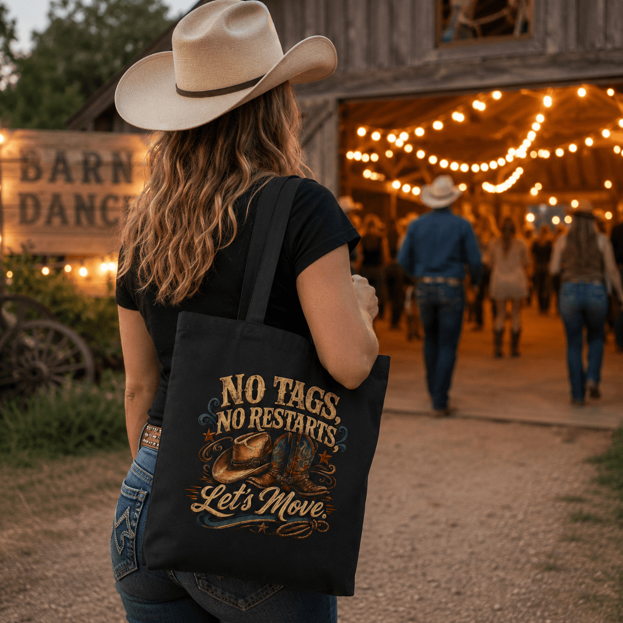 Person carrying a canvas tote bag with western ‘No Tags, No Restarts – Let’s Move’ line dancing artwork.
