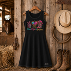 Black Peace Love Line Dance knee-length dress hanging in rustic barn with cowboy boots and hat