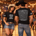Cowgirl wearing the front and cowboy showing the back of the black Step by Step line dancing T-shirt in a dance hall