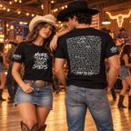 Cowgirl wearing the front and cowboy showing the back of the black Step by Step line dancing T-shirt in a dance hall
