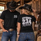 Woman in a navy line dancing T-shirt and man showing the black Stomp 2, 3, 4 Feel the Beat back print